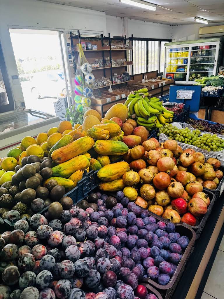Fresh papayas, pomegranates, grapes, bananas and plums inside Tsiakkouris Fruit Market